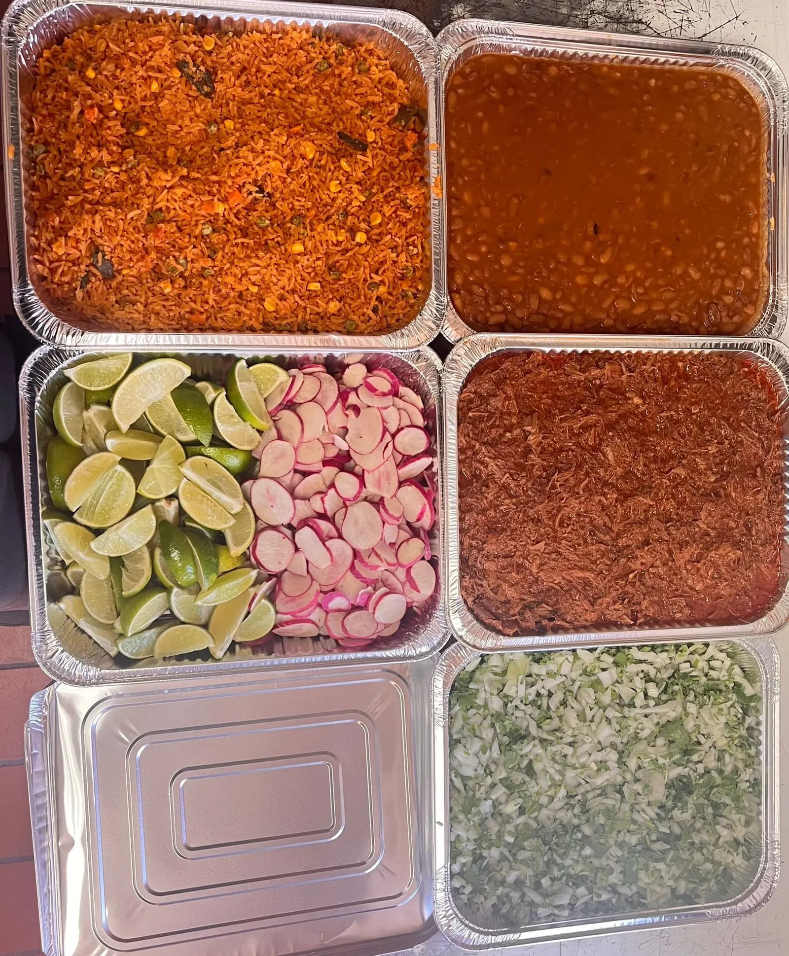 Mexican catering buffet trays with rice, beans and birria