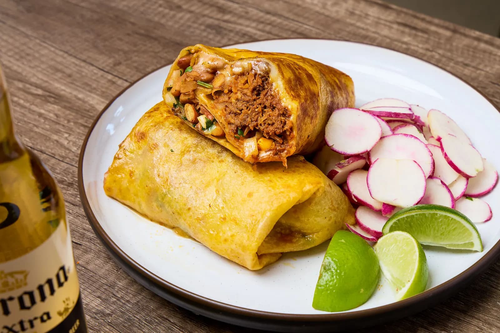 Birria burrito cut open with radish garnish