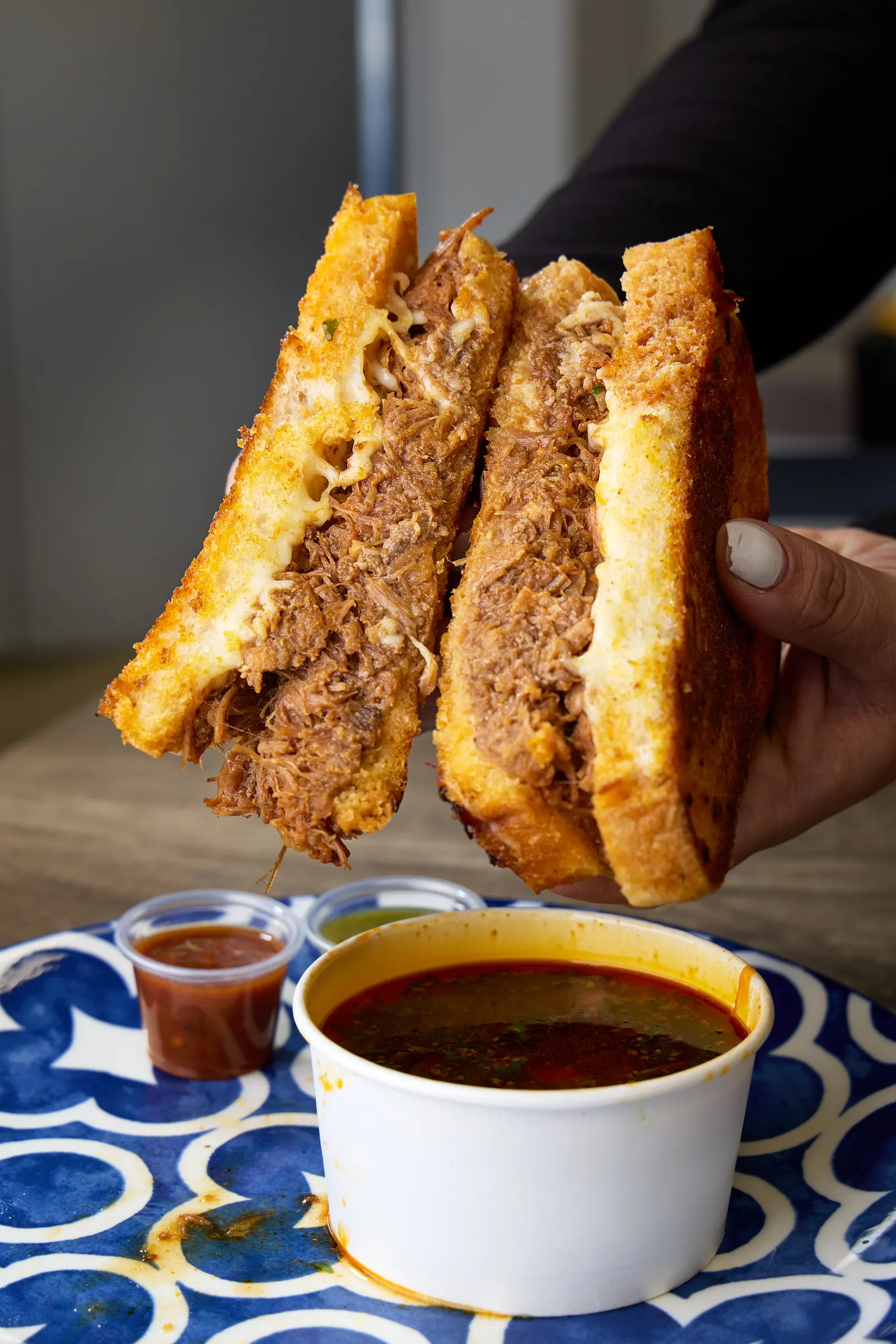 Birria grilled cheese with a side of consommé