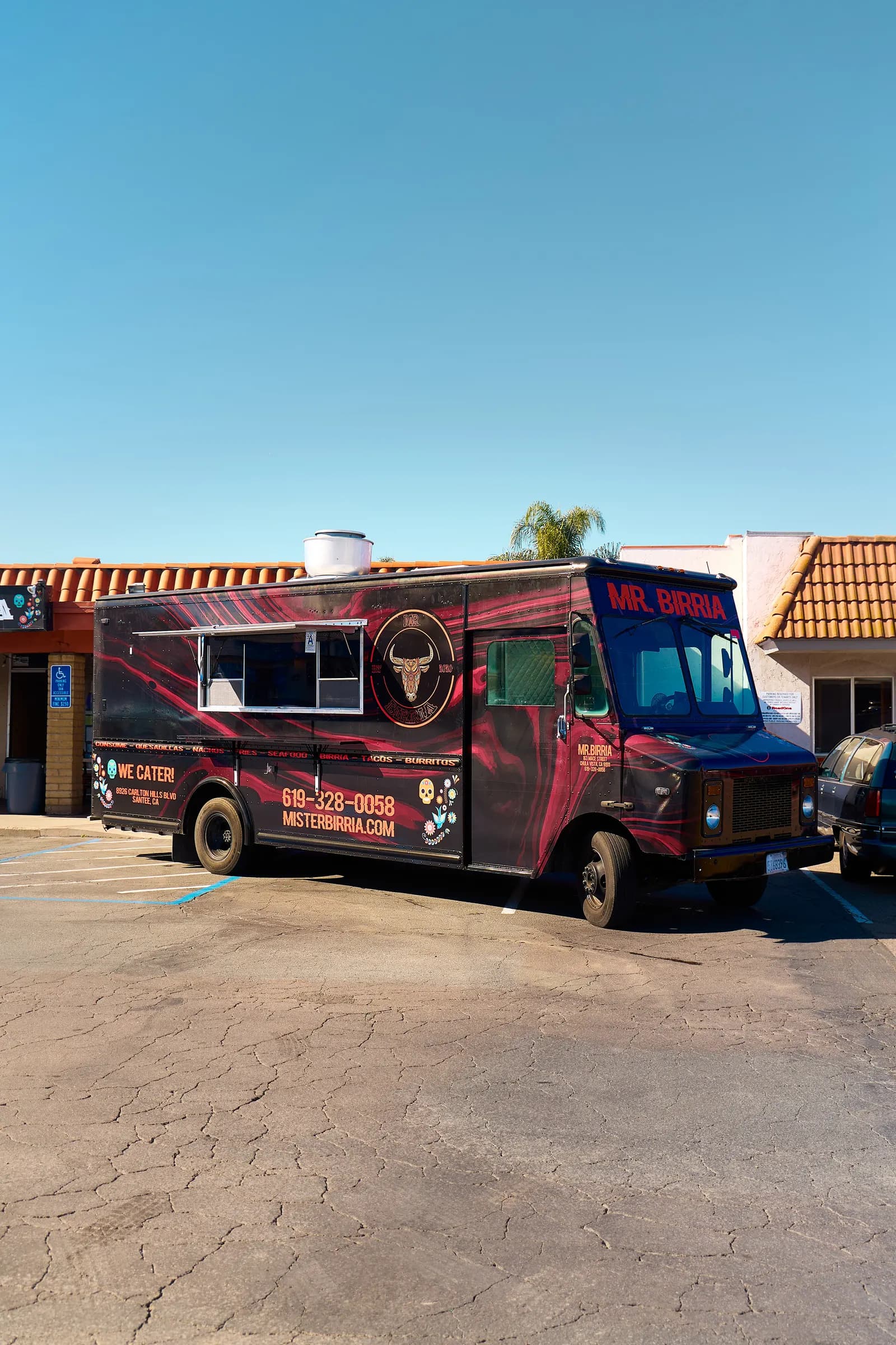 Guests ordering at the Mr. Birria taco truck window during an event